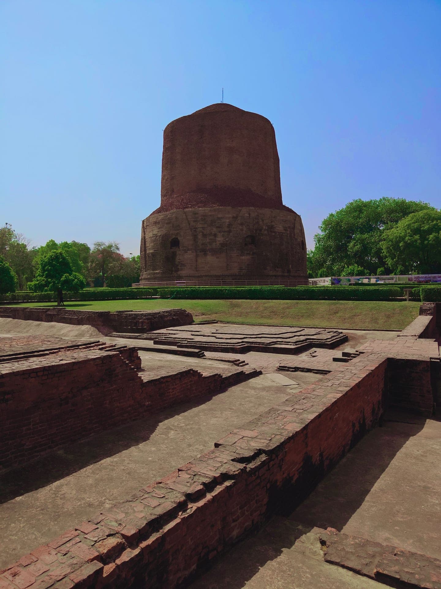 The Dhamek Stupa at Sarnath rising over the excavated brick ruins.